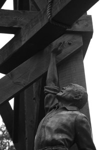 A lone man stands in the line of fire should that rope fray