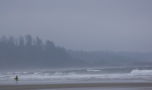 A surfer finds joy on a blustery day in Tofino, BC