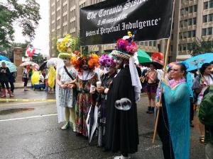 The Sisters pose with their banner